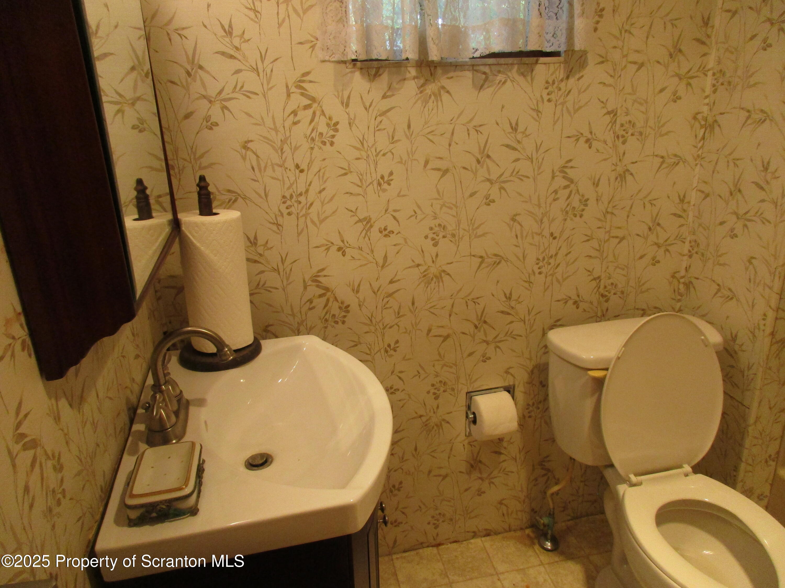 24 Oak Street Nicholson, PA 18446 - Photo 17 of 17 a bathroom with a toilet sink and mirror