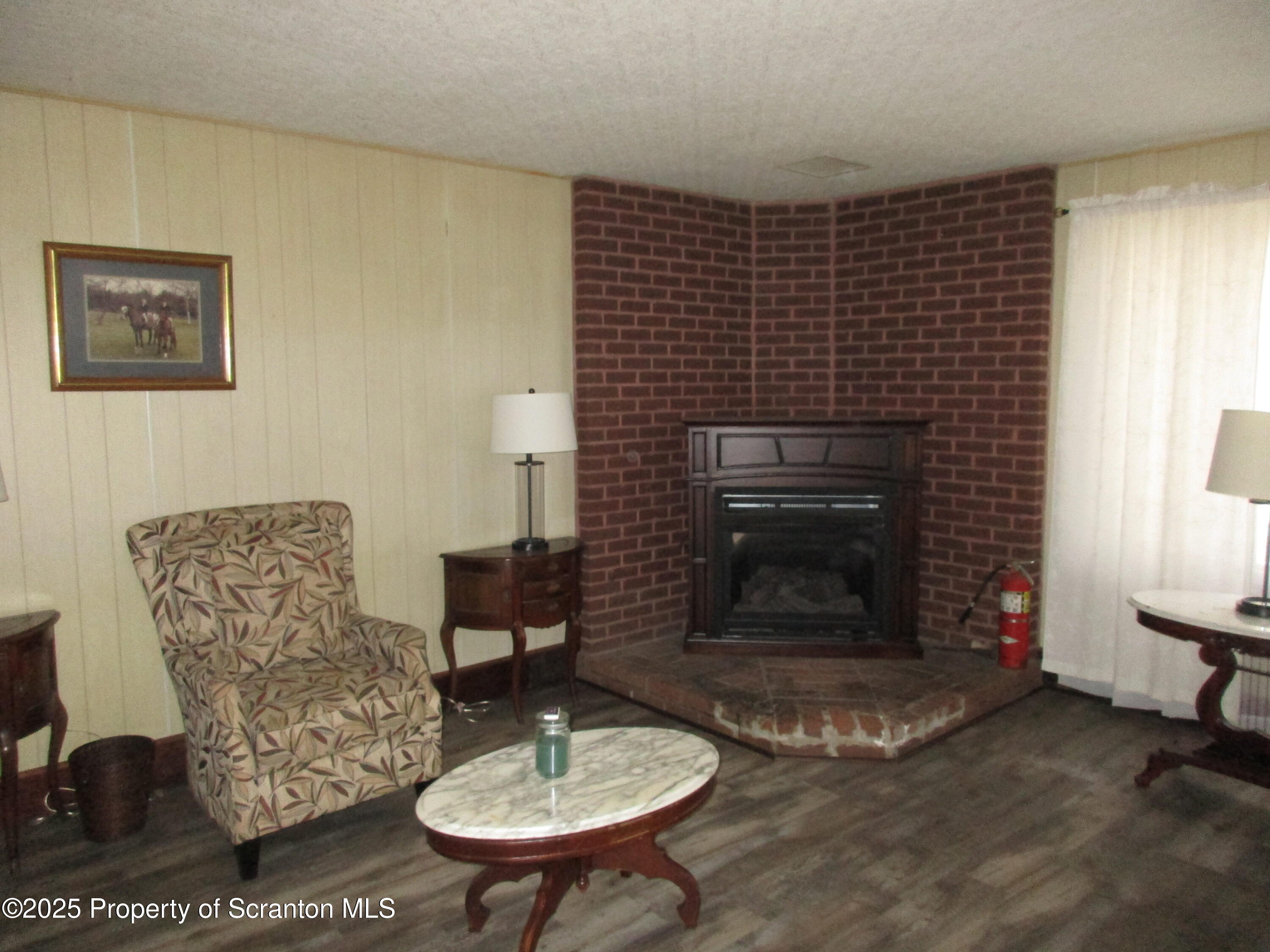 24 Oak Street Nicholson, PA 18446 - Photo 4 of 17 a living room with furniture and a fireplace