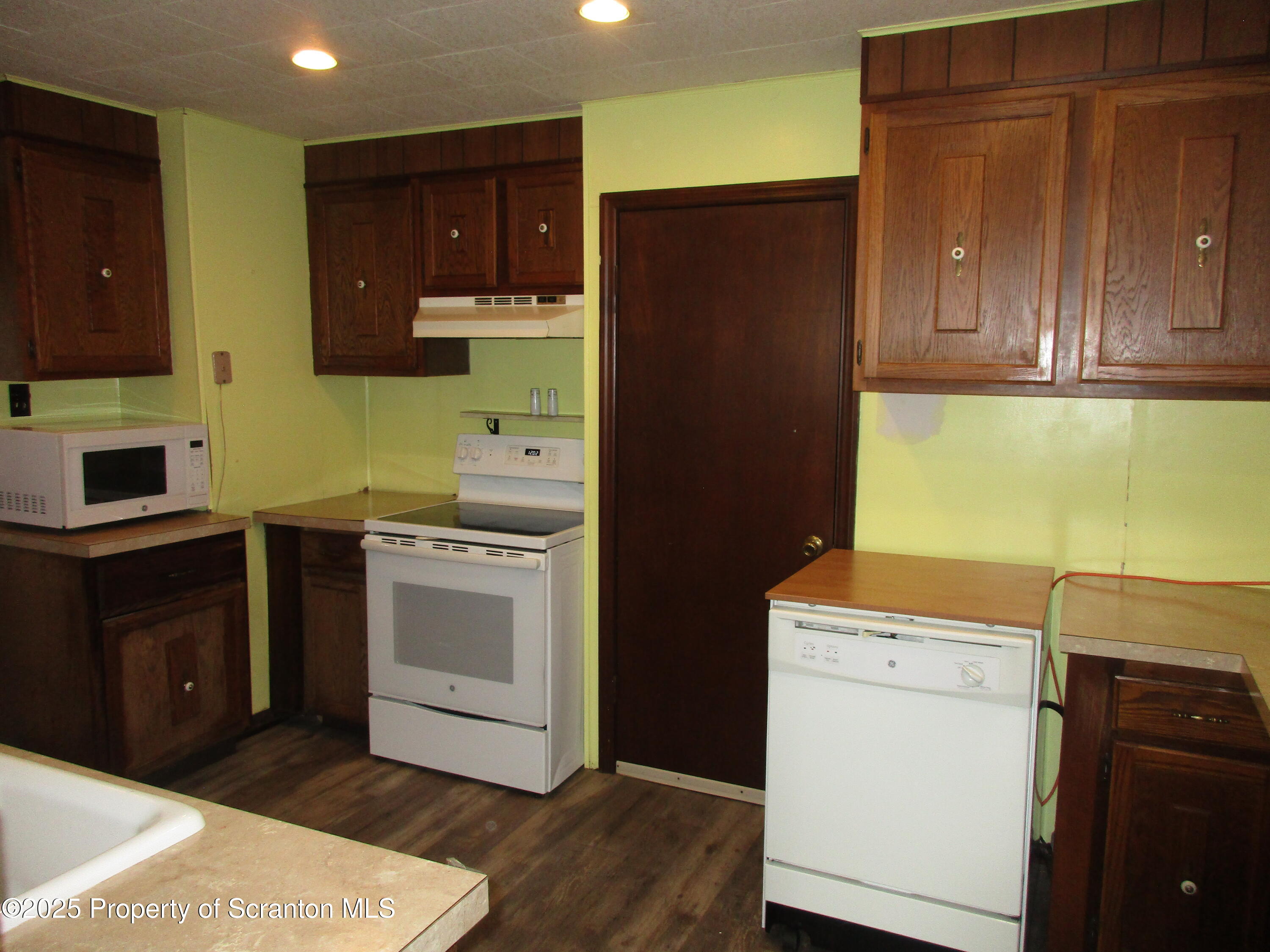 24 Oak Street Nicholson, PA 18446 - Photo 7 of 17 a kitchen with a refrigerator sink and cabinets