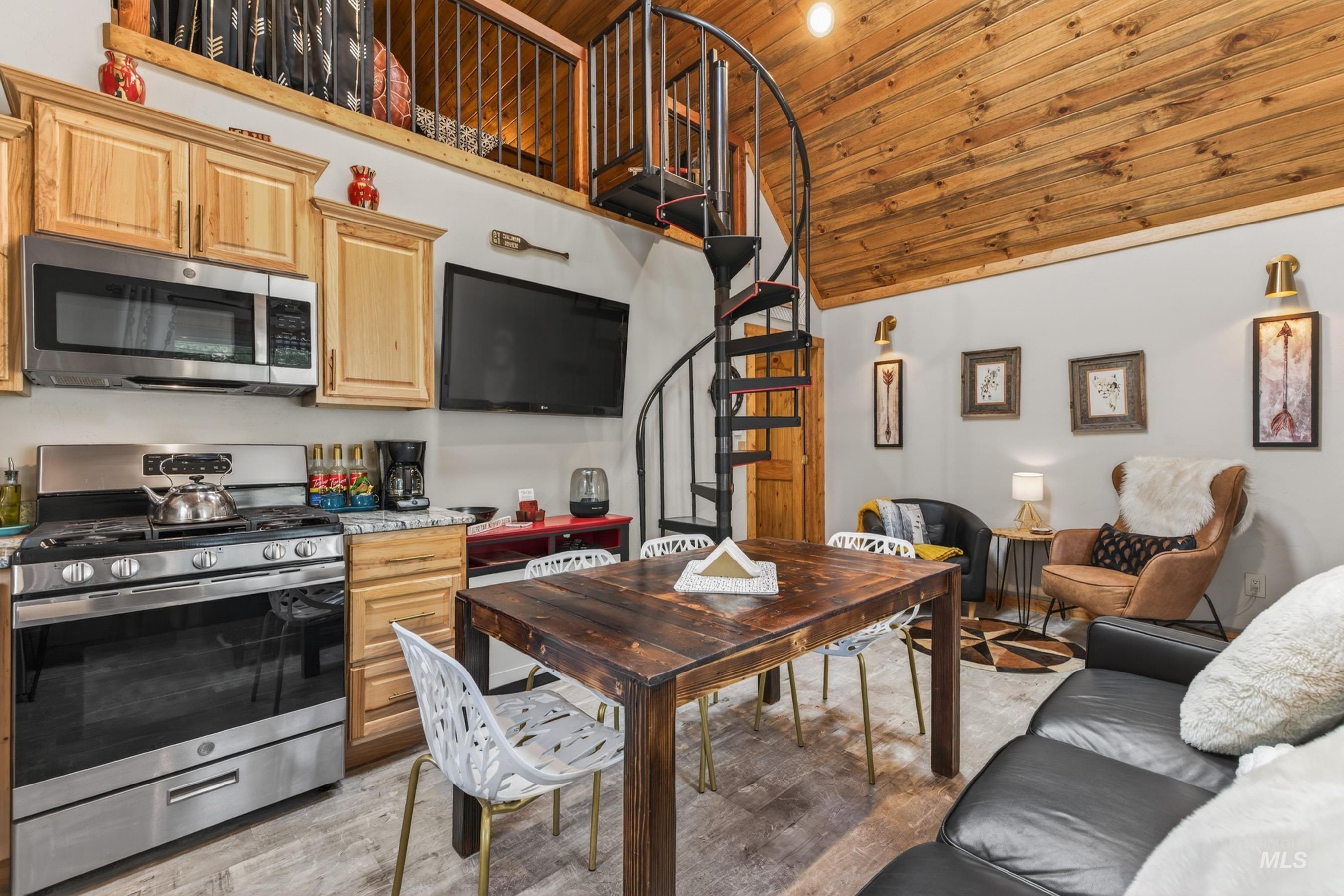 1432 Salmon Drive Riggins, ID 83549 - Photo 13 of 39 Vaulted wood-plank ceiling featuring a spiral staircase leading to a loft