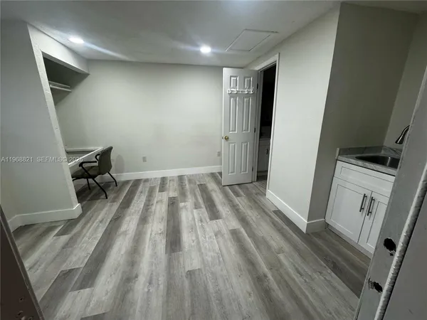 a view of a room with wooden floor and chair