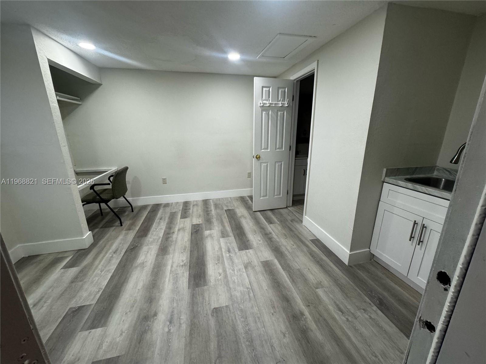 582 East 18th Street, Unit C Hialeah, FL 33013 - Photo 1 of 13 a view of a room with wooden floor and chair