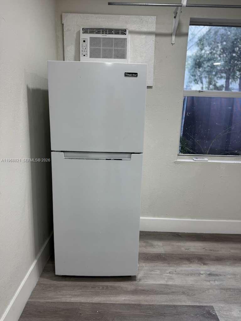 582 East 18th Street, Unit C Hialeah, FL 33013 - Photo 6 of 13 a white refrigerator freezer and a stove sitting inside of a kitchen