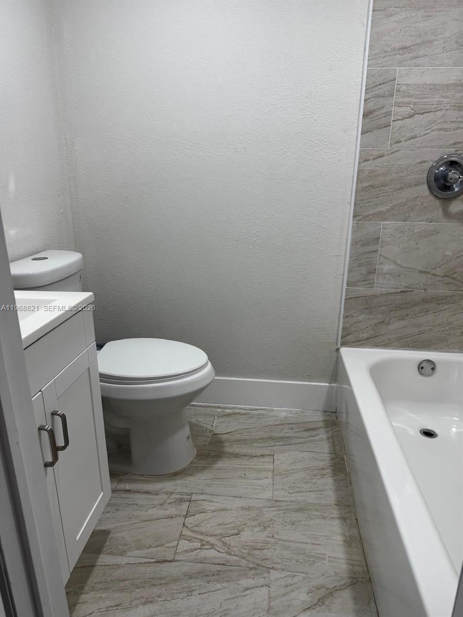 582 East 18th Street, Unit C Hialeah, FL 33013 - Photo 8 of 13 a bathroom with a sink and a toilet