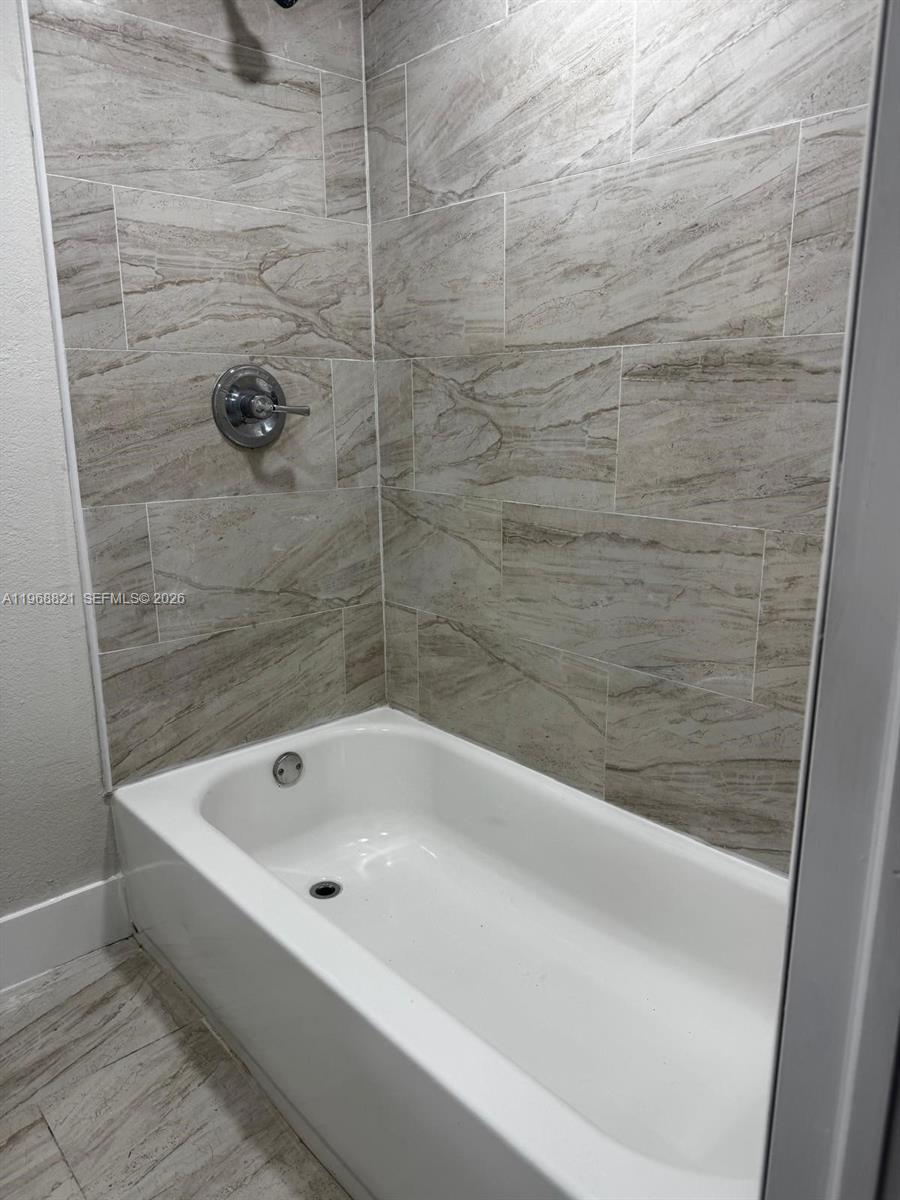 582 East 18th Street, Unit C Hialeah, FL 33013 - Photo 9 of 13 a bathroom with a bathtub