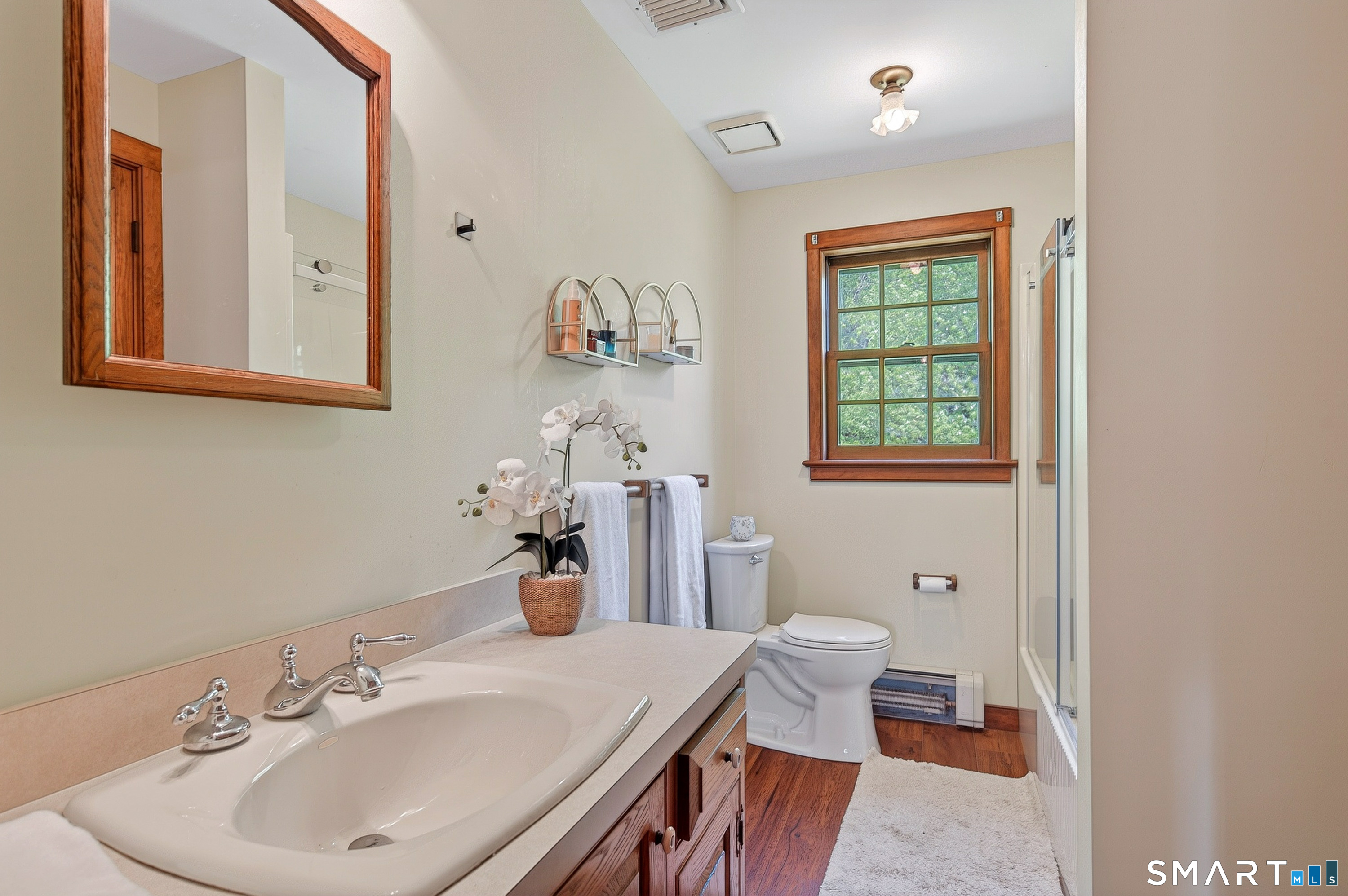 174 Huntingtown Road Newtown, CT 06470 - Photo 21 of 40 a bathroom with a sink and a mirror