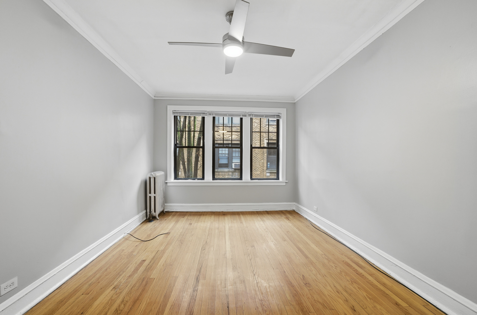 2336 West Addison Street, Unit I2 Chicago, IL 60618 - Photo 12 of 17 an empty room with wooden floor and windows