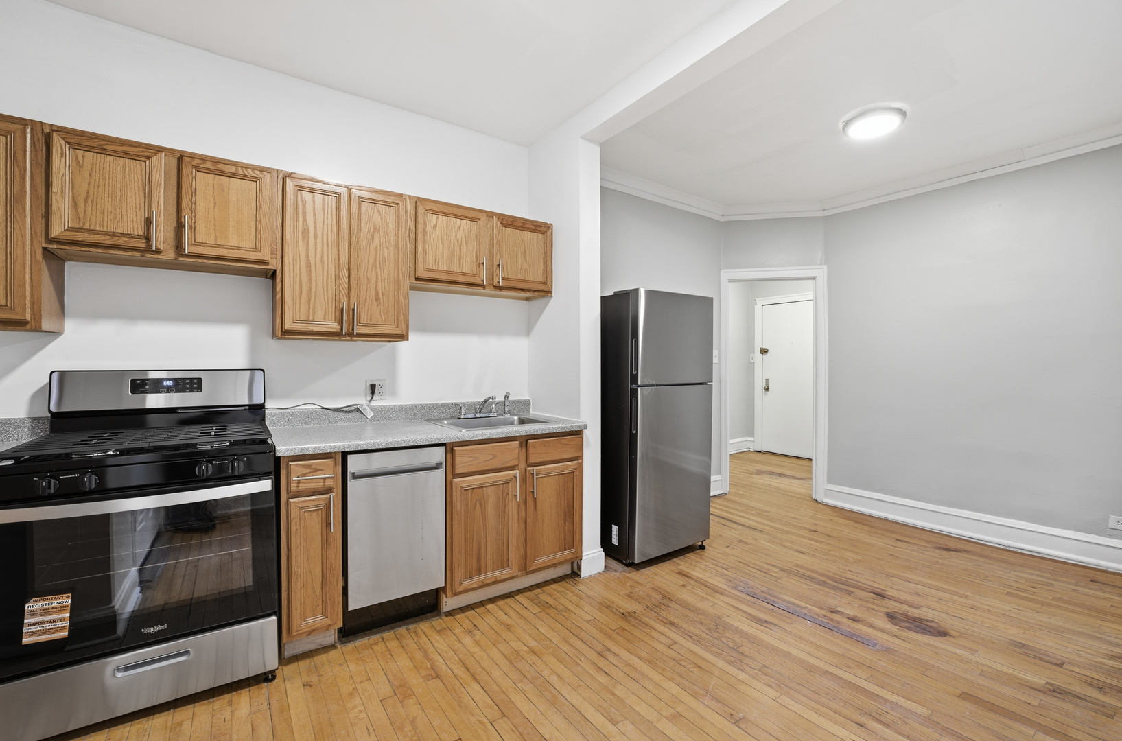 2336 West Addison Street, Unit I2 Chicago, IL 60618 - Photo 4 of 17 a kitchen with stainless steel appliances granite countertop a stove a refrigerator and a microwave