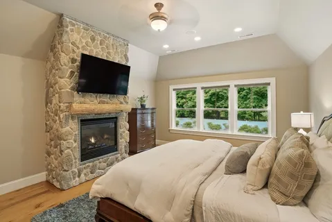 a bedroom with a bed and a flat screen tv