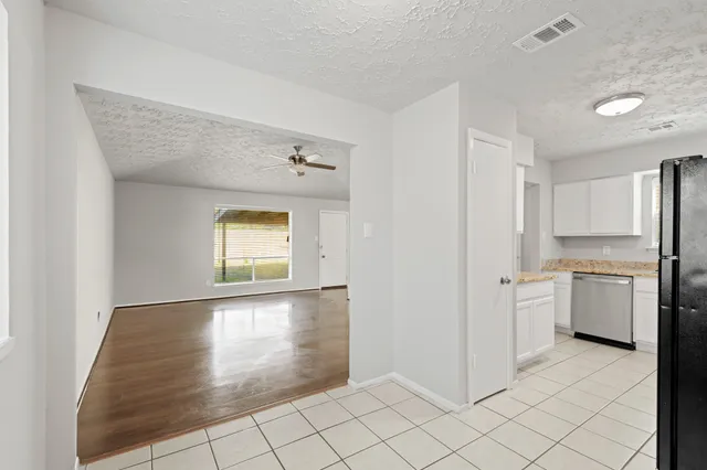 a view of a kitchen with a sink dishwasher and a refrigerator
