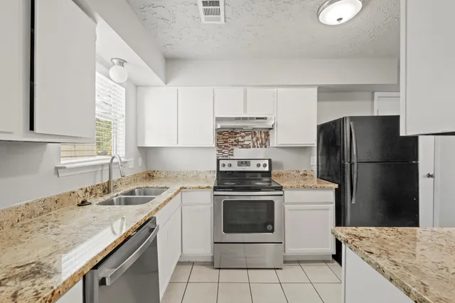 a kitchen with a stove sink and refrigerator