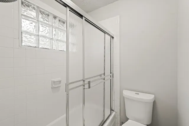a bathroom with a toilet and a shower