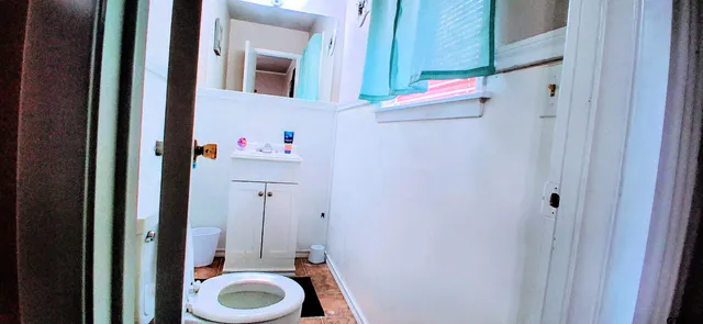 a bathroom with a toilet and a shower