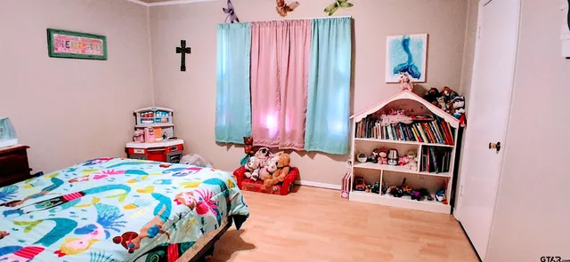 a bedroom with bed and a window