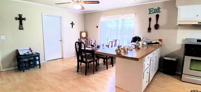 a kitchen with a sink and chairs