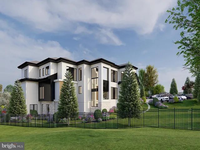 a front view of a house with a garden and trees