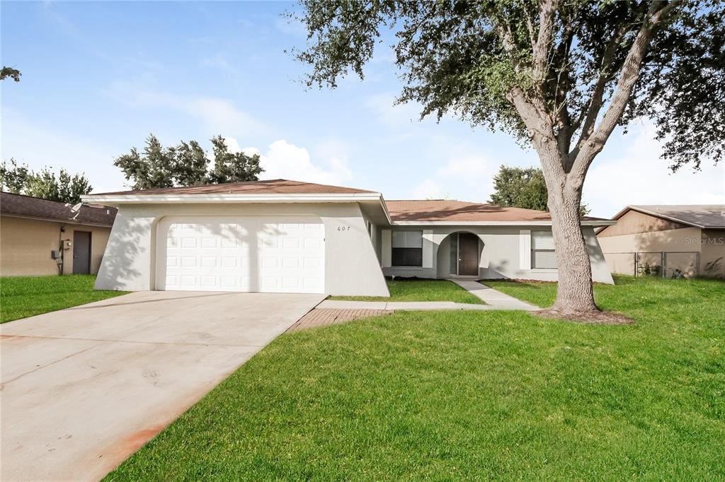 a front view of a house with a yard and garage
