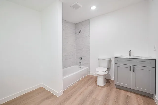 a bathroom with a toilet a sink and bathtub
