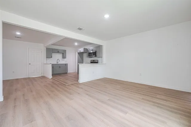 a view of a kitchen with a sink and a refrigerator