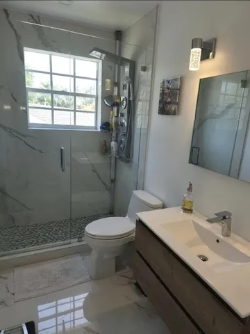 a bathroom with a sink toilet and shower