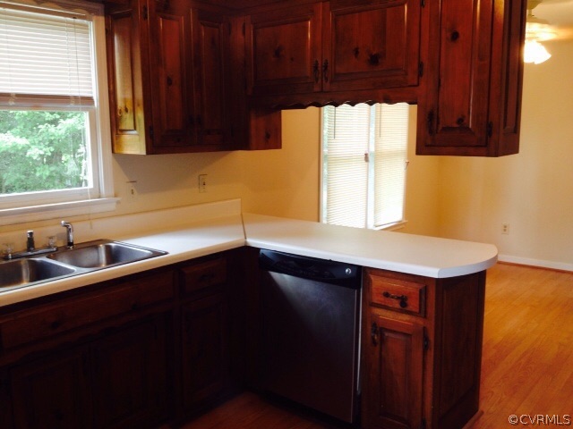 9303 Hunters Trail Road Petersburg, VA 23803 - Photo 4 of 7 a kitchen with a sink a window and cabinets
