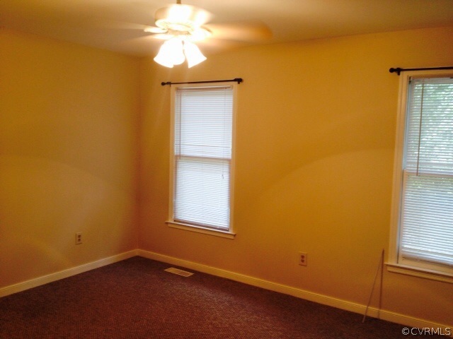 9303 Hunters Trail Road Petersburg, VA 23803 - Photo 7 of 7 an empty room with a window and a chandelier fan