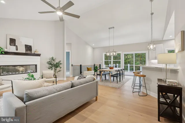 a living room with fireplace furniture and a large window