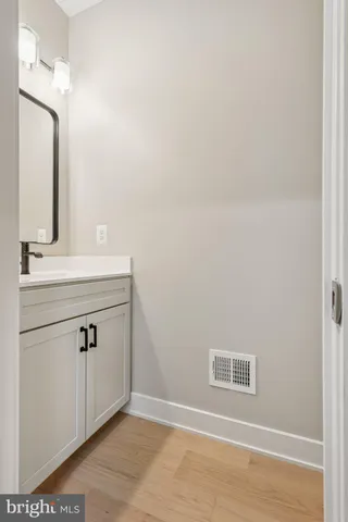 a bathroom with a sink vanity and a mirror