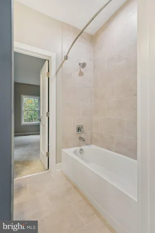a spacious bathroom with a bathtub and a shower