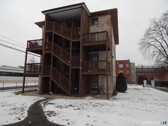 a view of a house with wooden fence