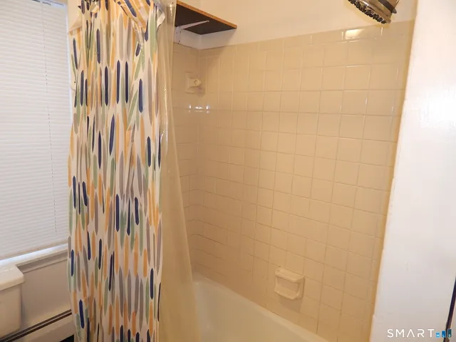 a bathroom with a shower and a tub