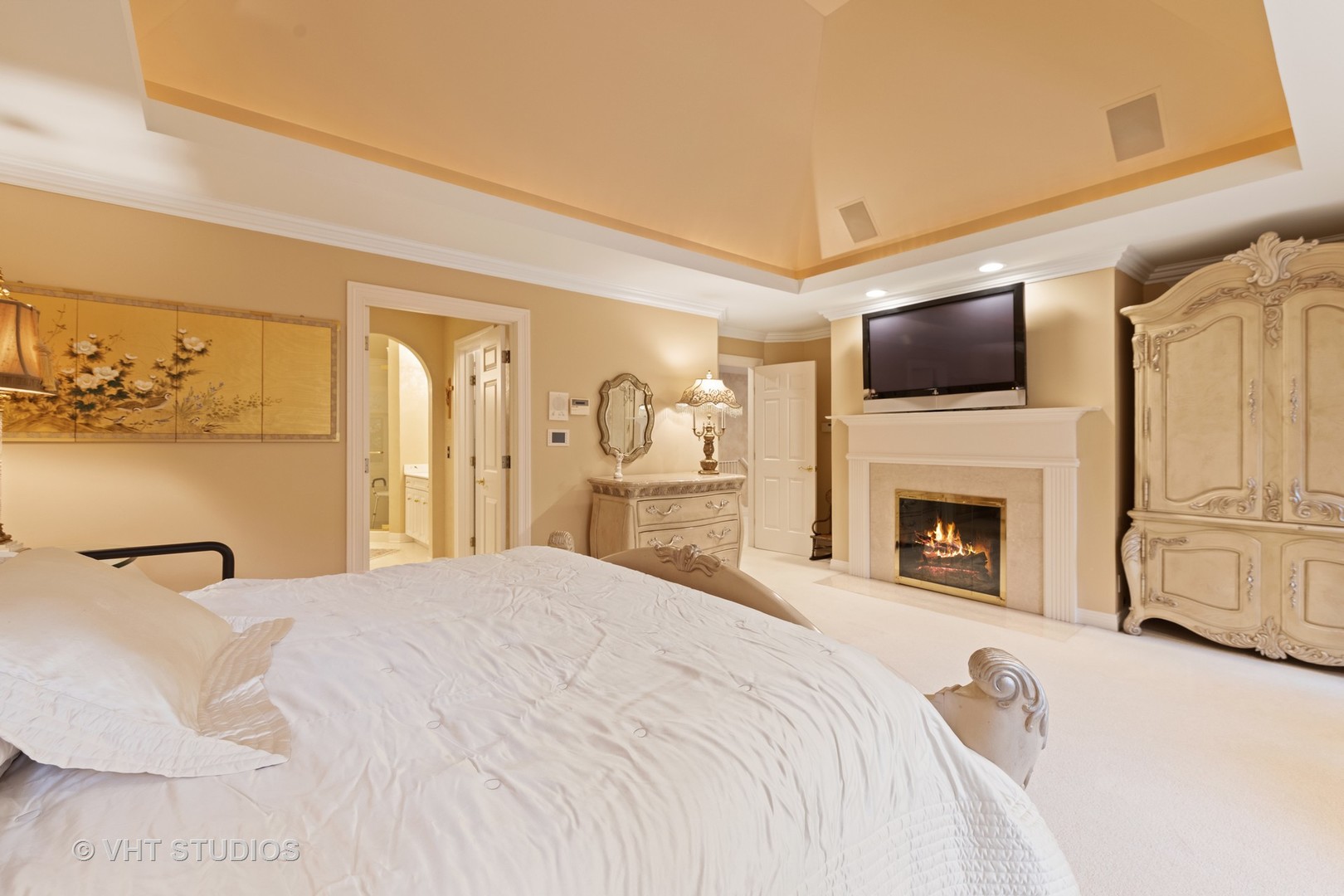 9301 Falling Waters Drive East Burr Ridge, IL 60527 - Photo 33 of 44 a spacious bedroom with a large bed and a flat screen tv