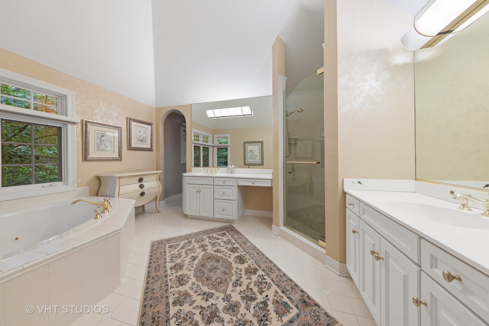 9301 Falling Waters Drive East Burr Ridge, IL 60527 - Photo 34 of 44 a spacious bathroom with a sink a mirror a bathtub and shower