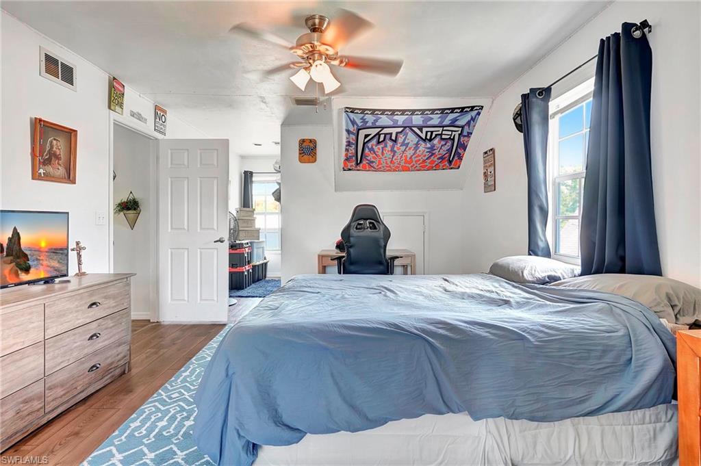 4211 Cindy Avenue Naples, FL 34112 - Photo 18 of 25 a bedroom with a bed and a large mirror on the dresser