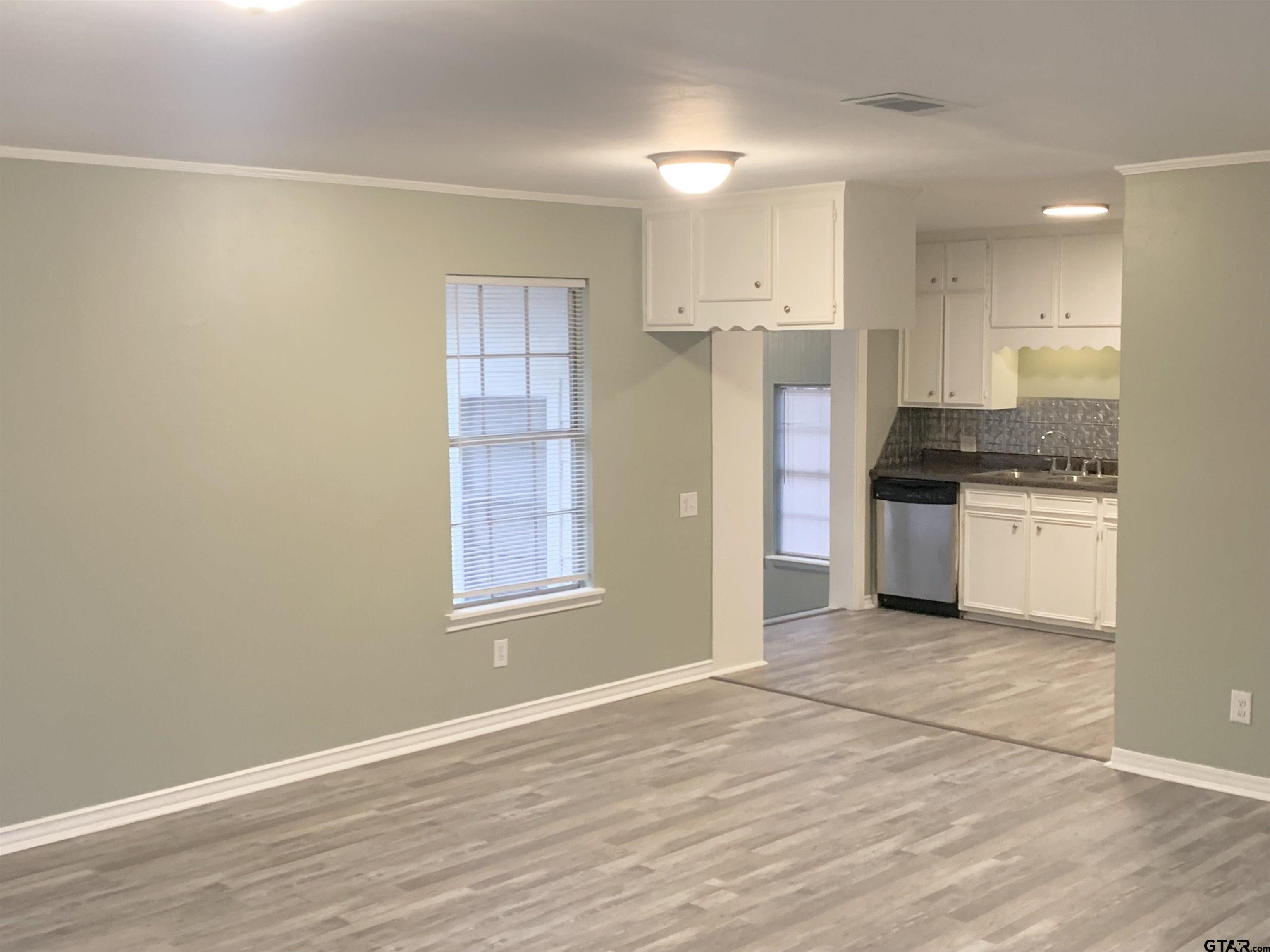 901 Cliff Street Quitman, TX 75783 - Photo 2 of 16 a view of a kitchen with a stove cabinets and wooden floor