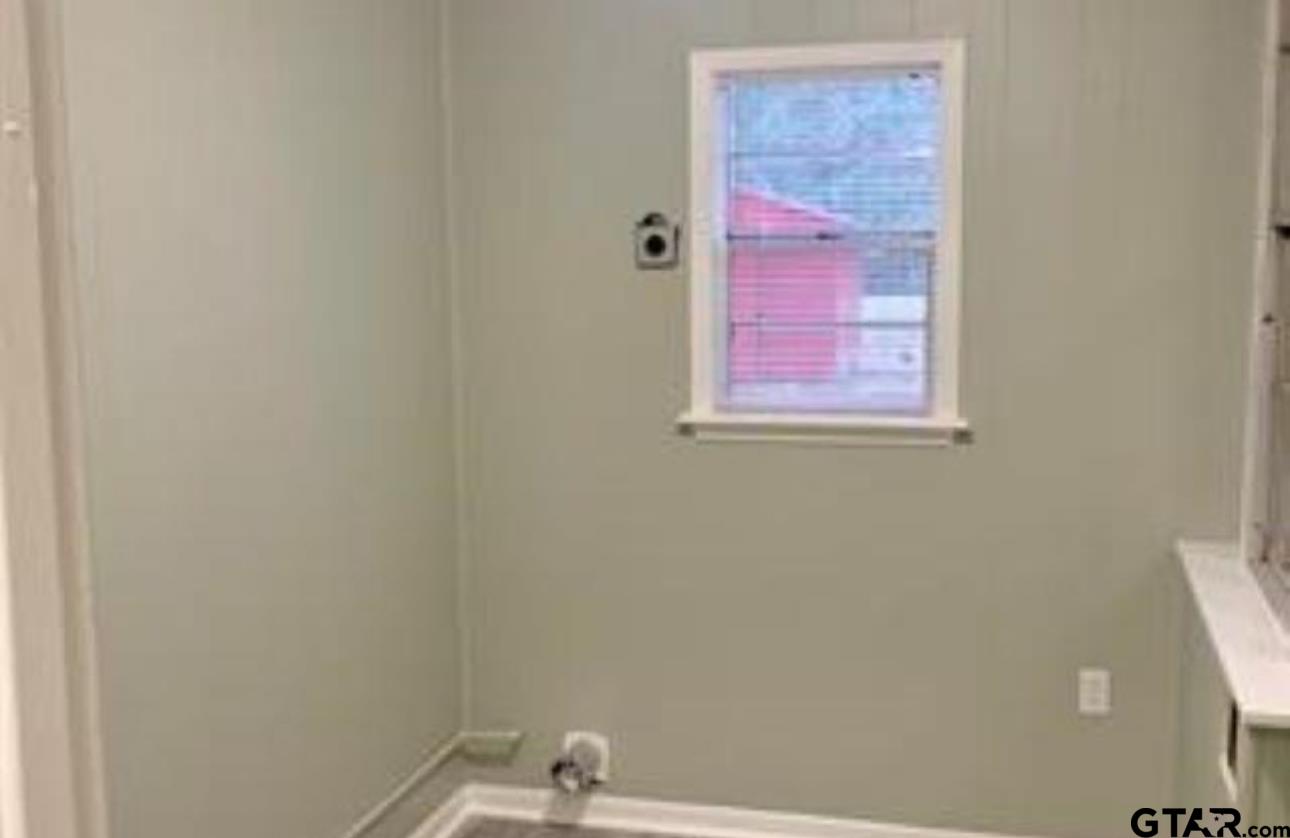 901 Cliff Street Quitman, TX 75783 - Photo 6 of 16 a bathroom with a sink and a mirror