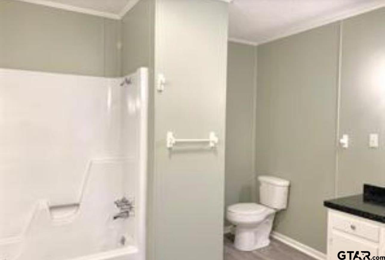901 Cliff Street Quitman, TX 75783 - Photo 10 of 16 a bathroom with a toilet and a shower