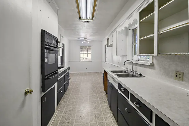 a kitchen with a sink appliances and cabinets
