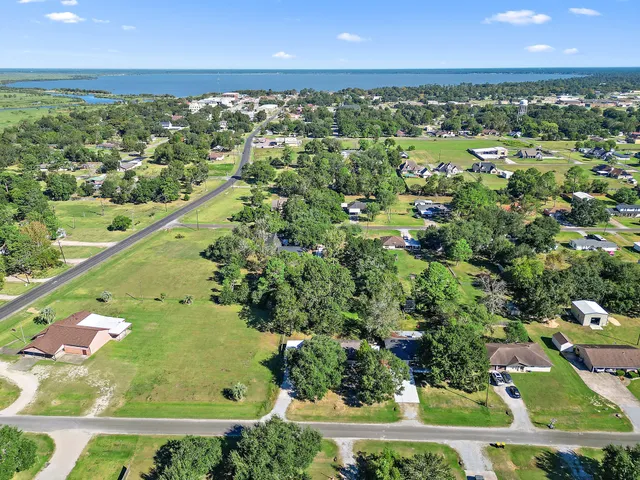 an aerial view of residential houses with outdoor space and street view