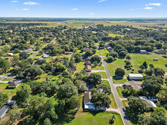 an aerial view of residential houses with outdoor space and swimming pool