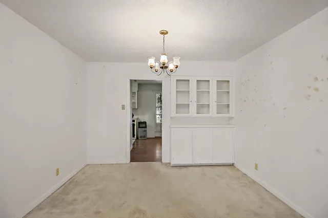 a view of a hallway with a chandelier