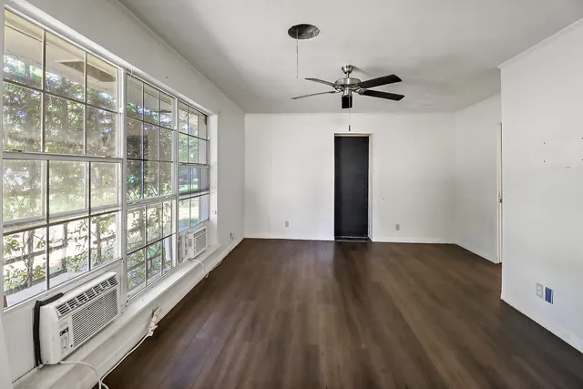 wooden floor in an empty room with a window