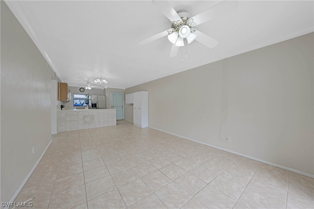 26485 Rampart Boulevard, Unit A6 Punta Gorda, FL 33983 - Photo 17 of 32 a view of a livingroom with a chandelier fan