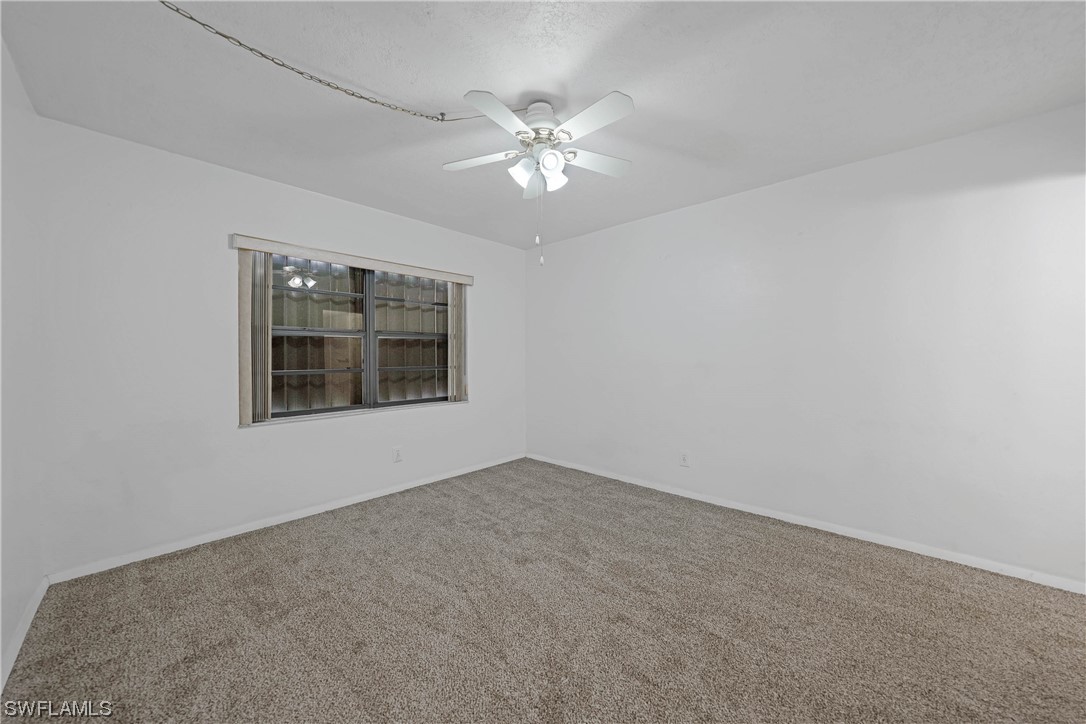26485 Rampart Boulevard, Unit A6 Punta Gorda, FL 33983 - Photo 18 of 32 a view of a livingroom with a ceiling fan and window
