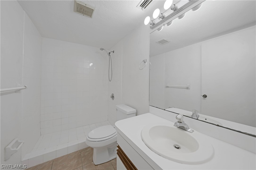 26485 Rampart Boulevard, Unit A6 Punta Gorda, FL 33983 - Photo 21 of 32 a bathroom with a sink a toilet and shower