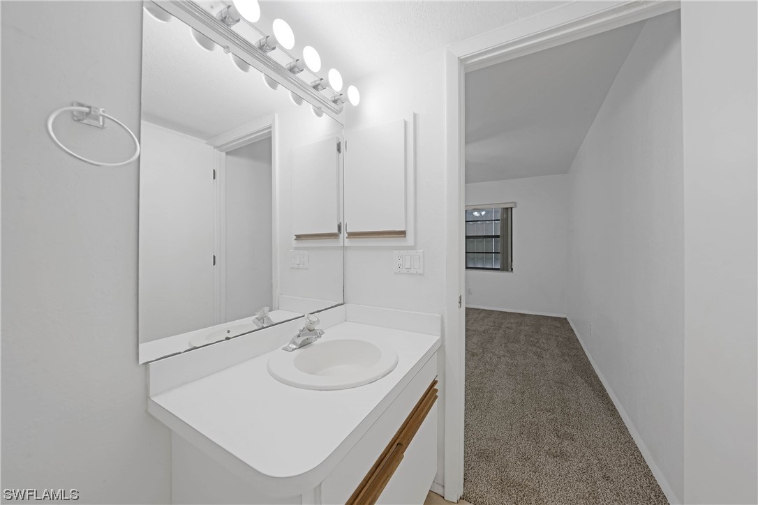 26485 Rampart Boulevard, Unit A6 Punta Gorda, FL 33983 - Photo 22 of 32 a bathroom with a sink and a mirror