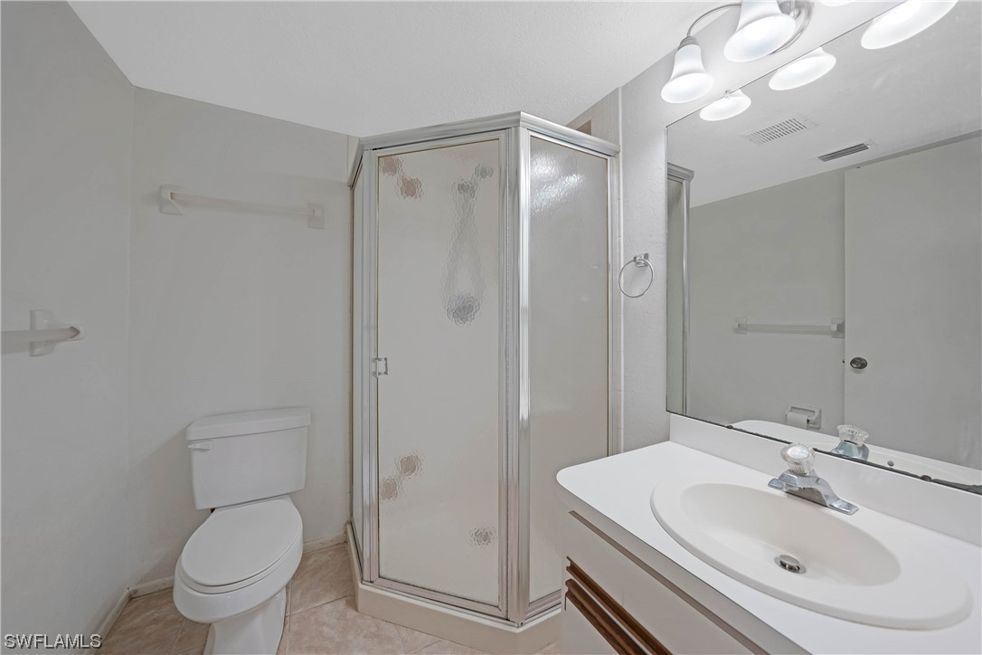 26485 Rampart Boulevard, Unit A6 Punta Gorda, FL 33983 - Photo 25 of 32 a bathroom with a sink toilet and shower