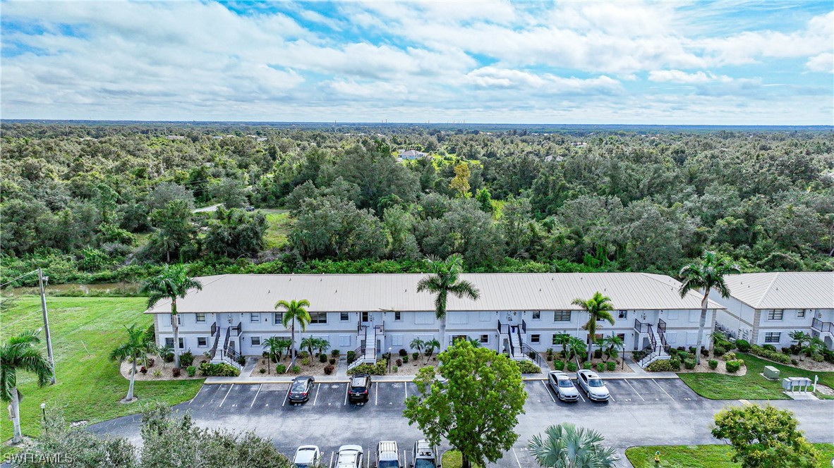 26485 Rampart Boulevard, Unit A6 Punta Gorda, FL 33983 - Photo 4 of 32 an aerial view of a house with garden space and street view