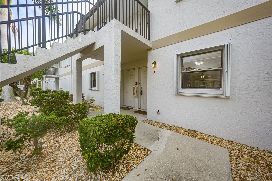 26485 Rampart Boulevard, Unit A6 Punta Gorda, FL 33983 - Photo 7 of 32 a front view of a house with a yard