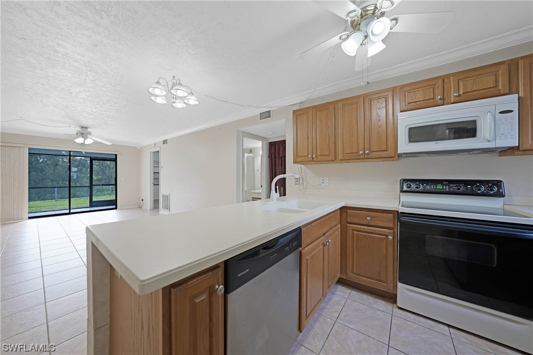 26485 Rampart Boulevard, Unit A6 Punta Gorda, FL 33983 - Photo 9 of 32 a kitchen with a sink cabinets and window